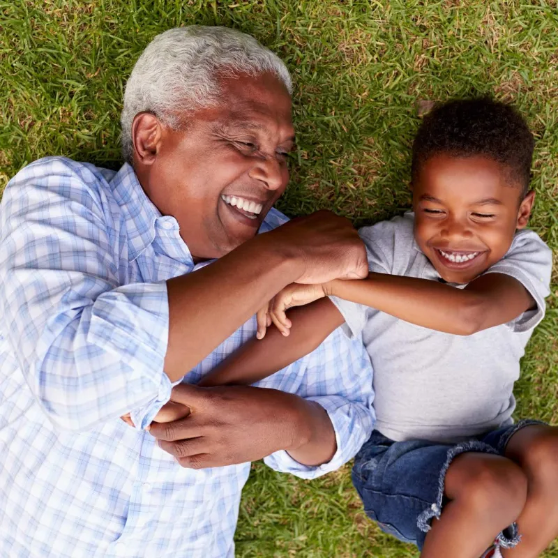 Grandfather playing with young grandson. 