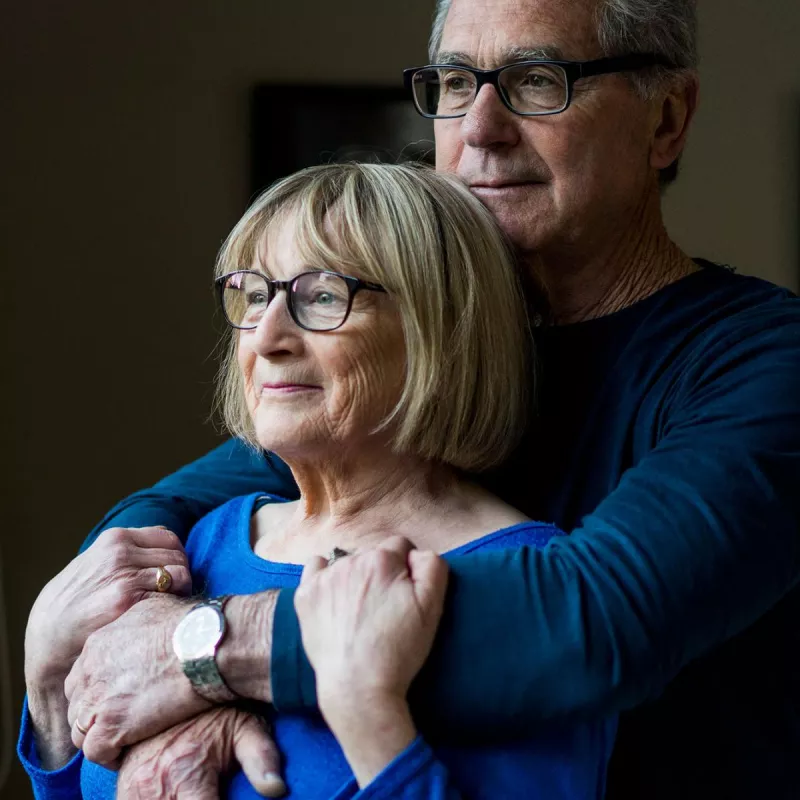 Elderly white couple embracing 