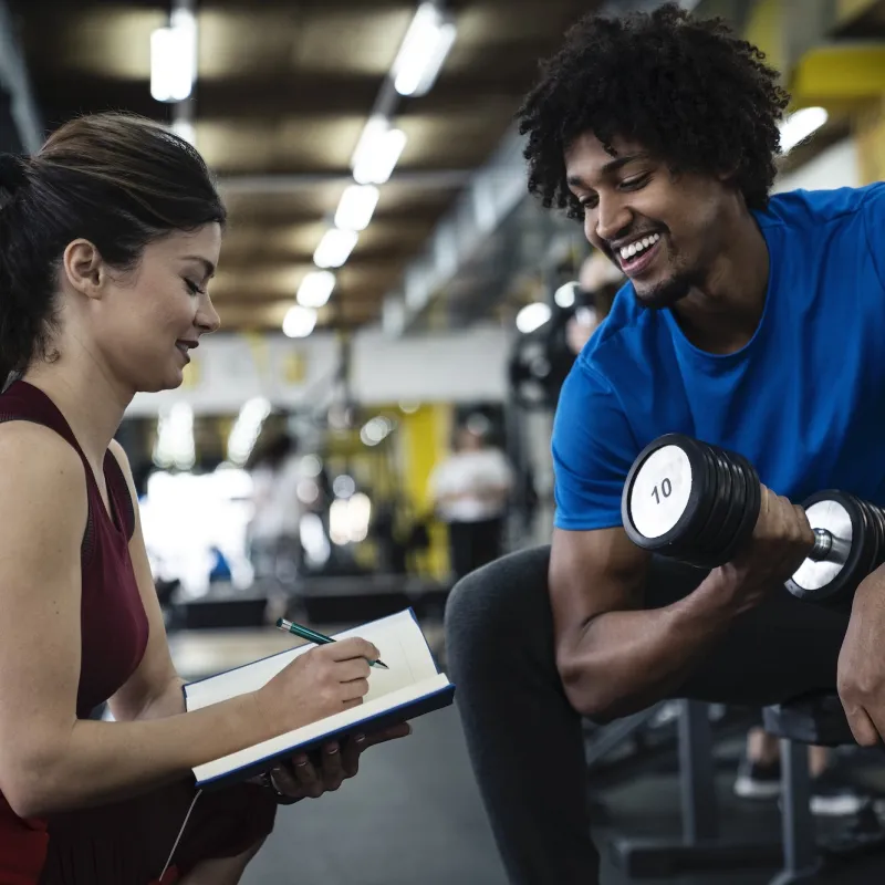 A man exercising with a personal trainer.