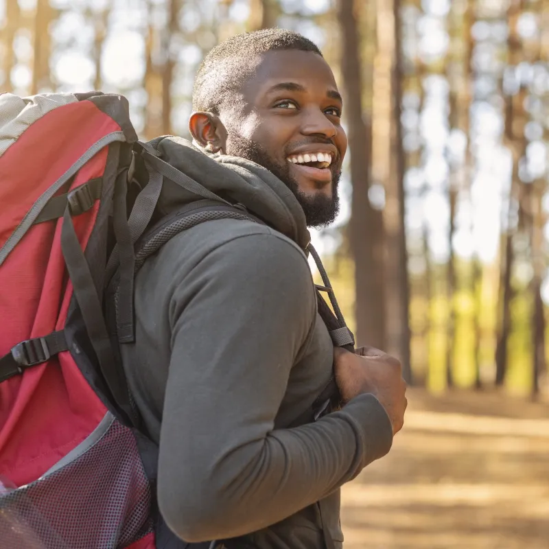 A man hiking in the woods. 