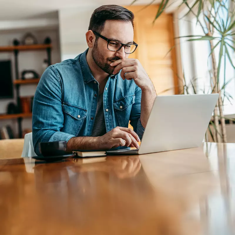 A man doing research on a laptop.