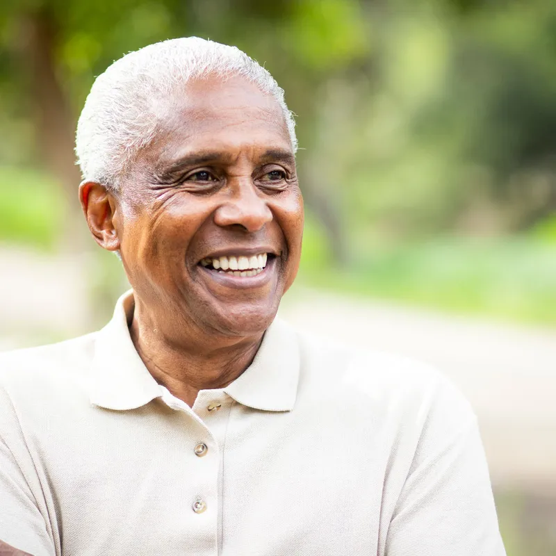 A man smiling outside. 