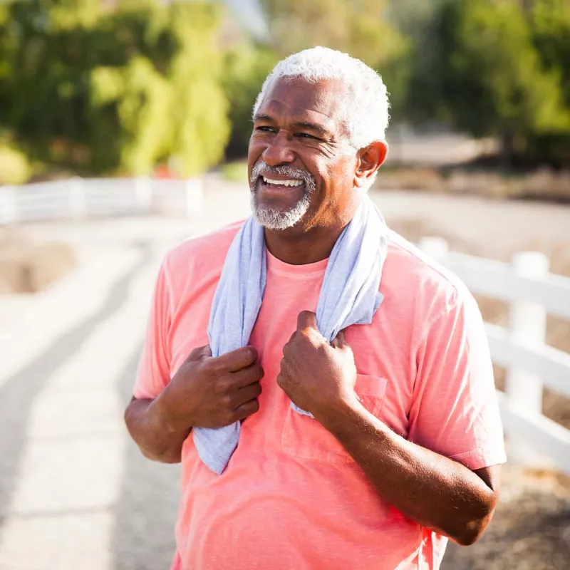 A senior gentleman taking a breather from exercise