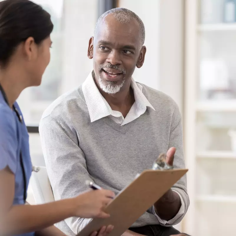 A man discussing his care with his doctor.