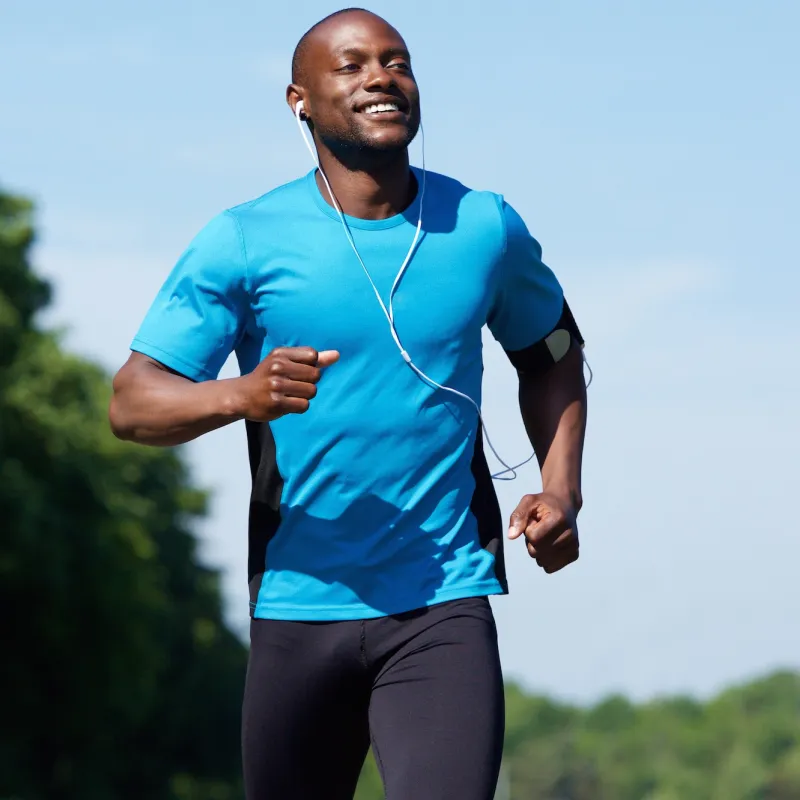 A man running outside while listening to music.