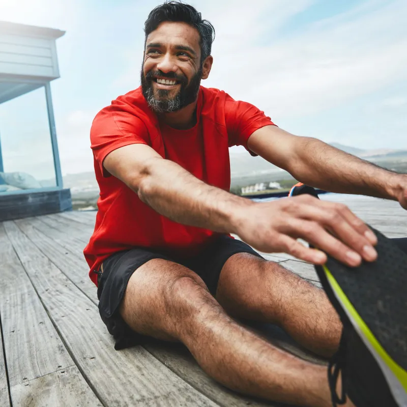 A man stretches his lower back after a workout.