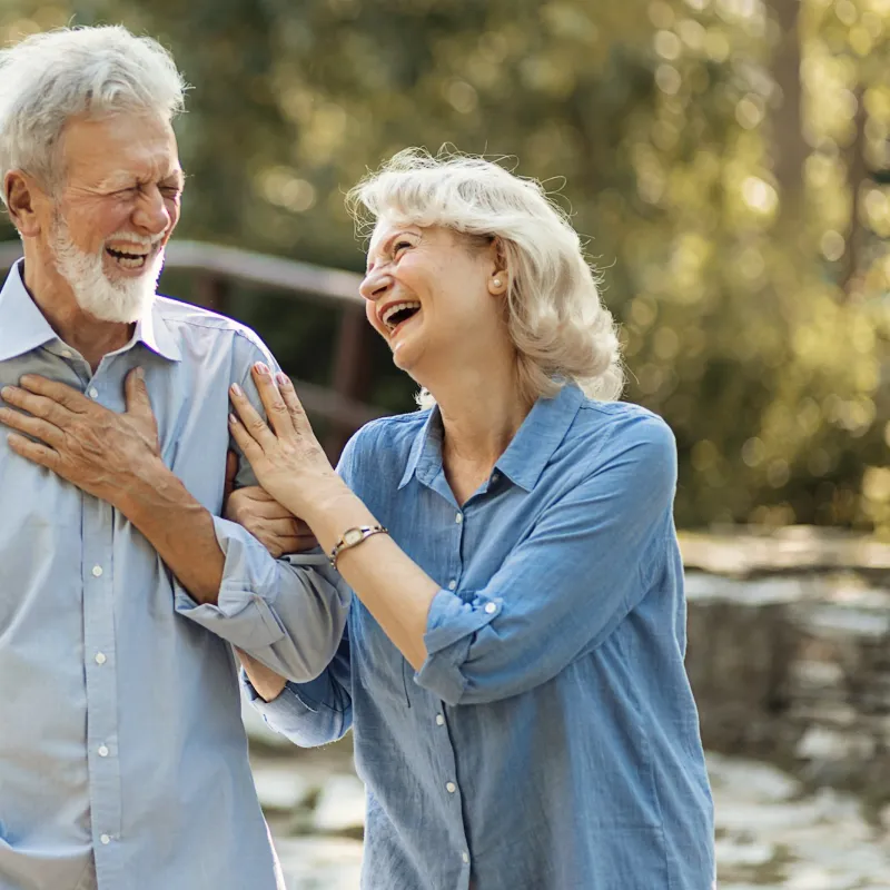 A mature couple walking outdoors.