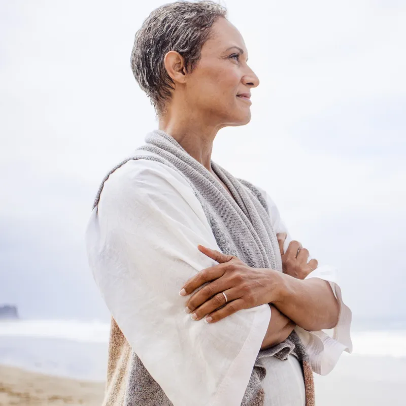 A woman standing on the beach.