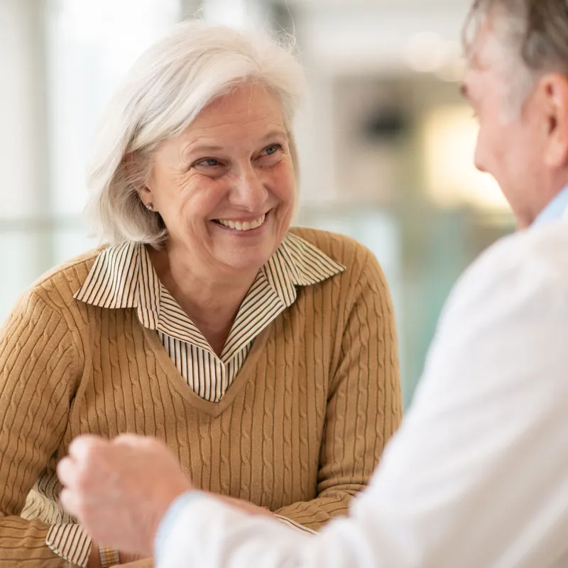 A woman discusses her health with her doctor.