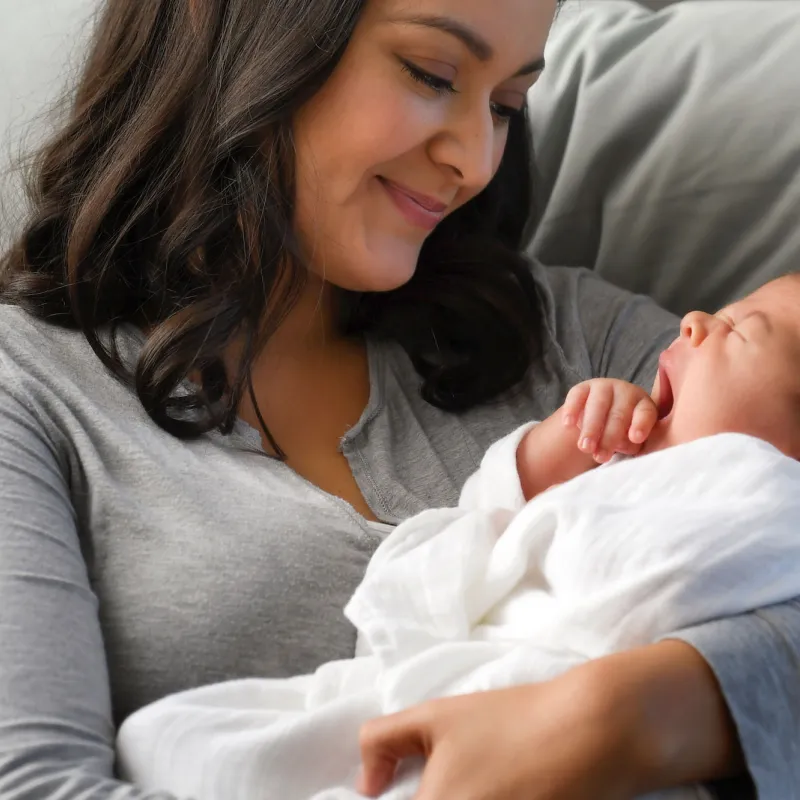 A mom holds her newborn infant.