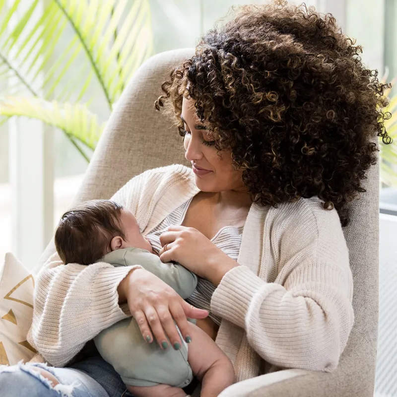 A new mom breastfeeding her infant. 