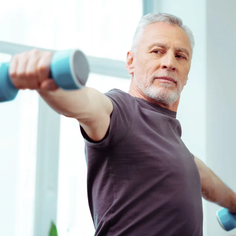 Man lifting weights at home.