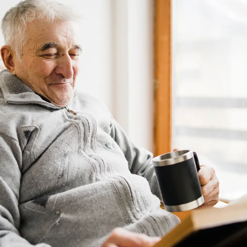 An older man reading. 