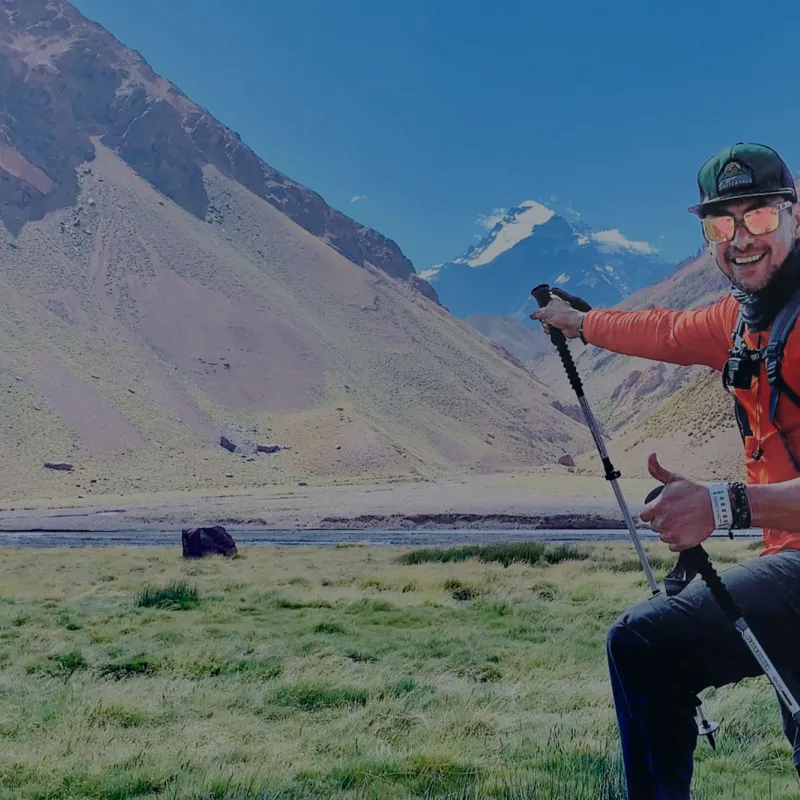 Man giving a thumbs up during a mountain climbing hike