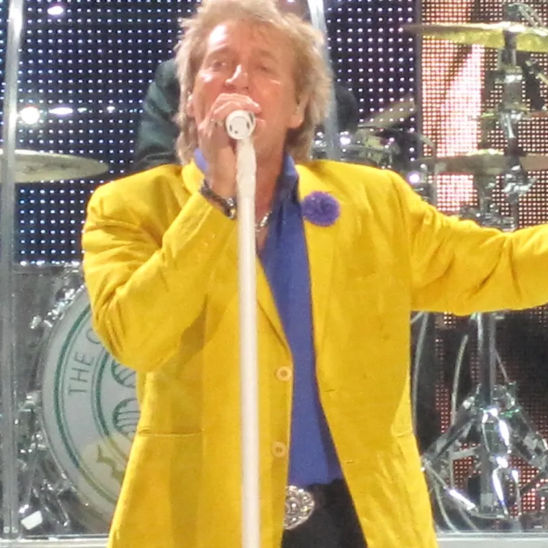 Rod Stewart performing on stage. 