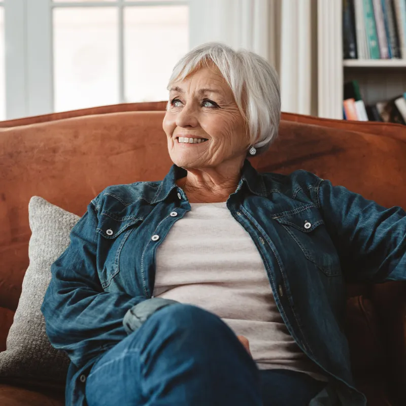 A woman relaxing at home on her couch.