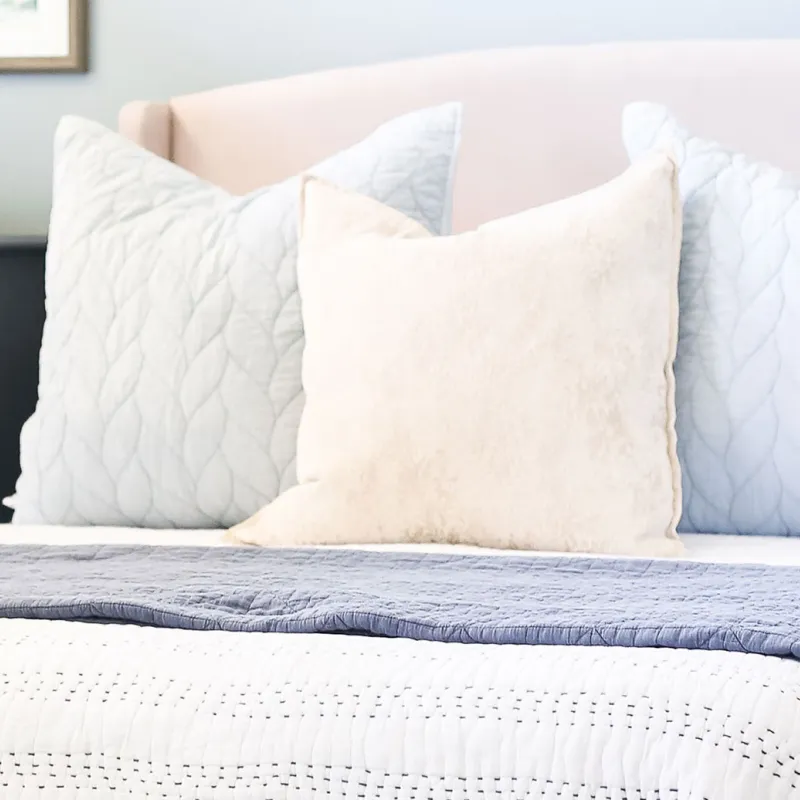 Tidy bedroom with a bed and dresser.