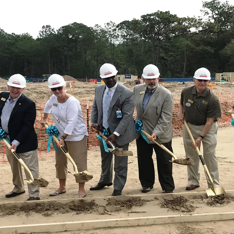 Employees celebrate groundbreaking ceremony