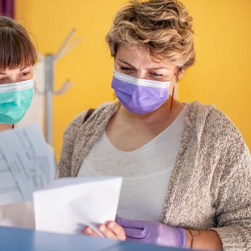 A doctor and patient looking at a medical chart. 