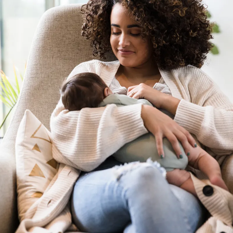 A new mom holding her infant. 