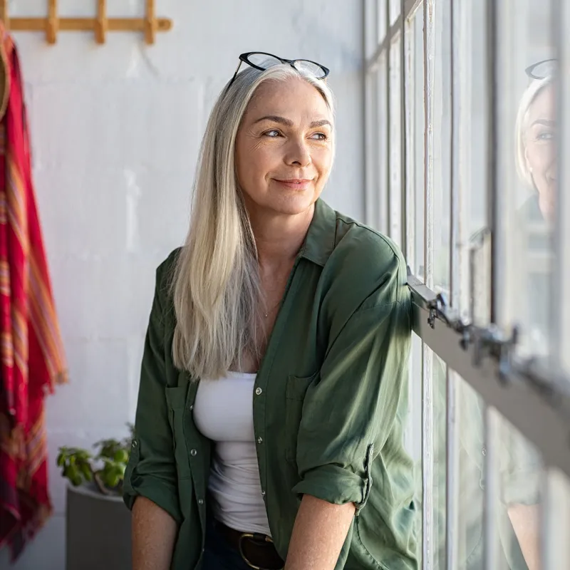 A woman sitting by the window. 