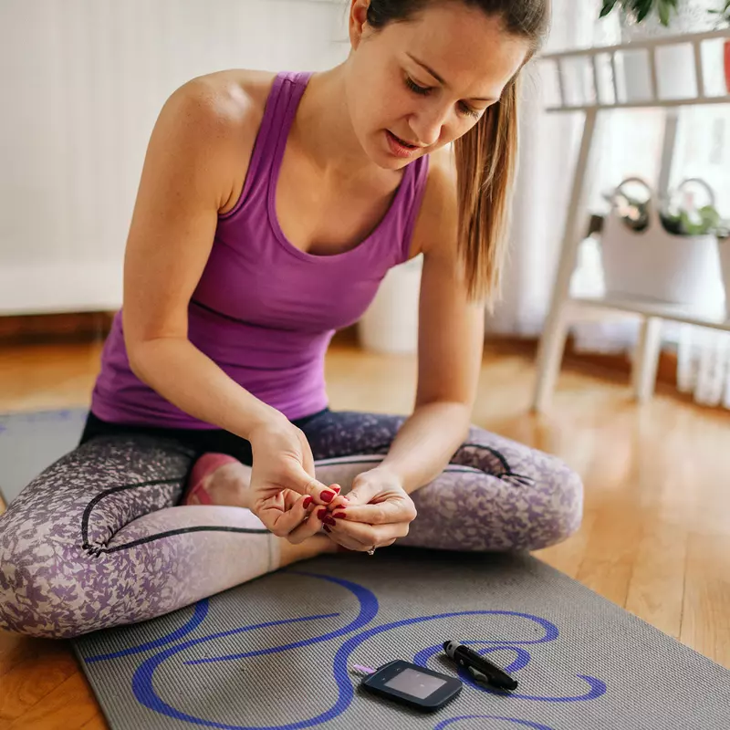 A woman checking her blood sugar.