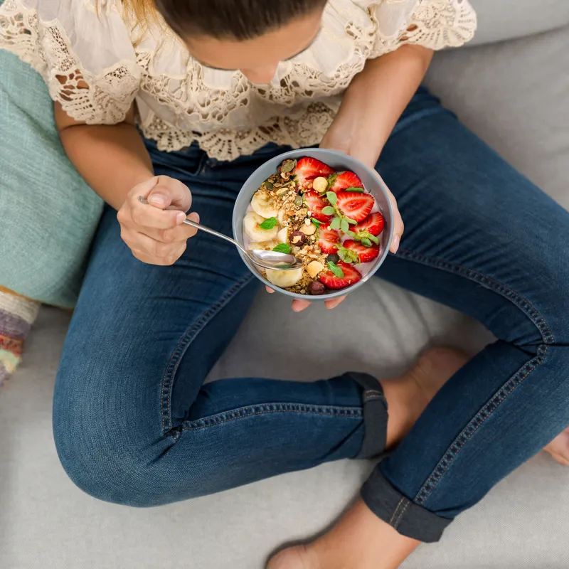 A woman eating a plant-based meal