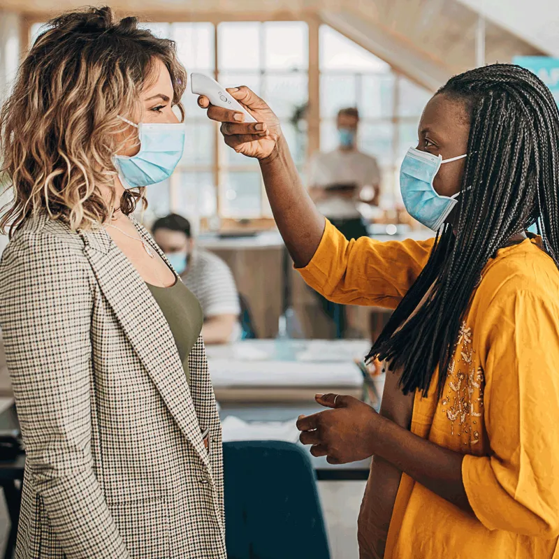 A woman getting her temperature checked