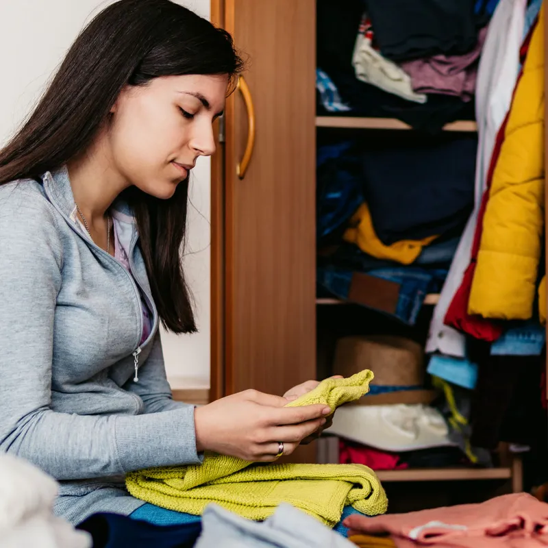 a woman donates her clothing