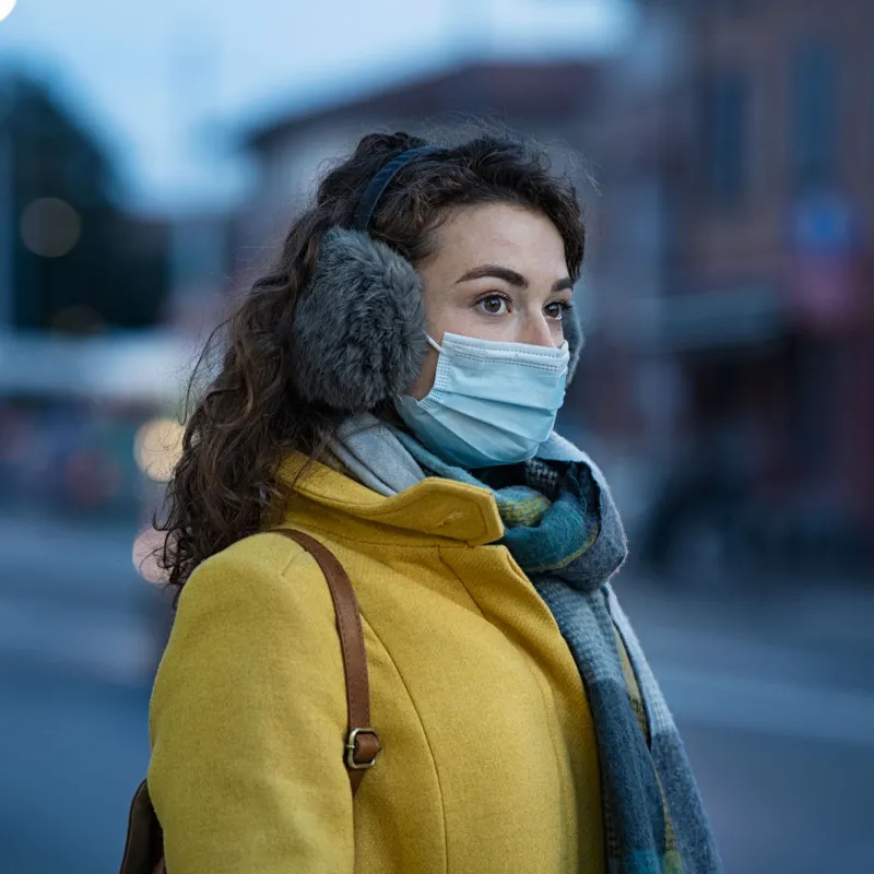 A young woman with winter gear while in her local city.