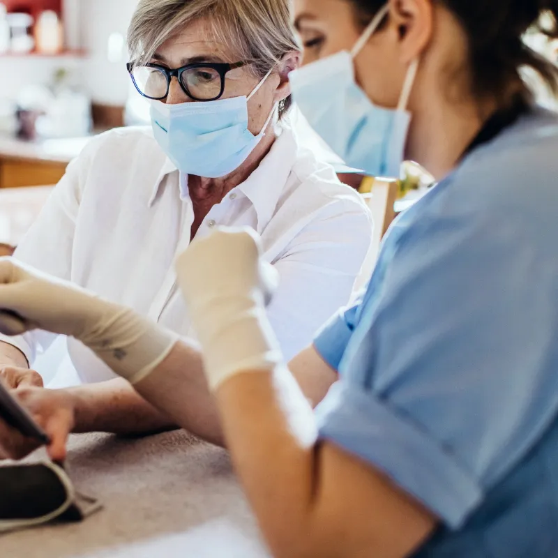 A woman reviews her test results with her provider safely. 