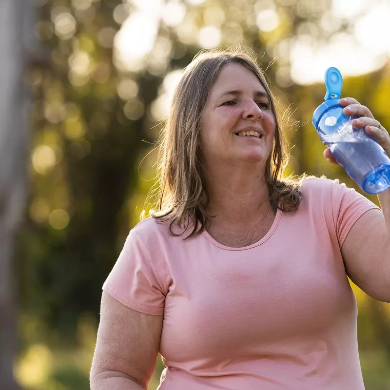 Overweight woman exercising outside