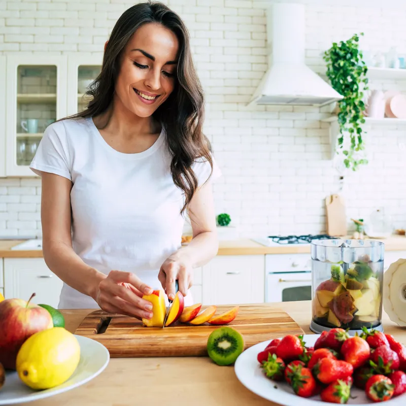 A young woman prepping food at home.