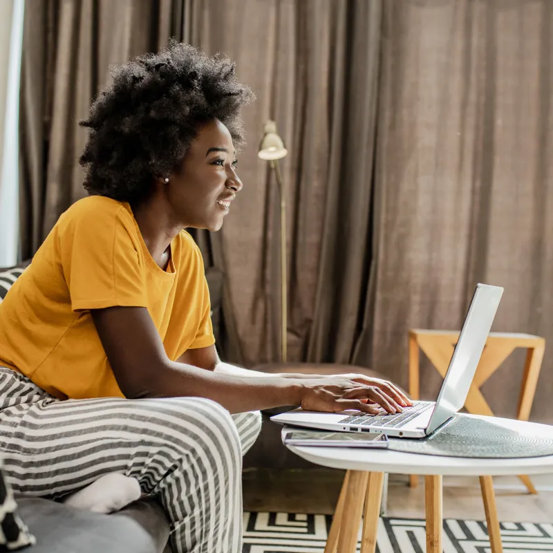 A woman on her laptop at her house