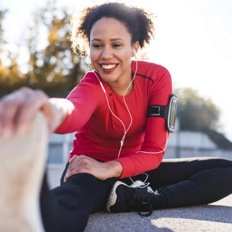 A woman stretching after a run.