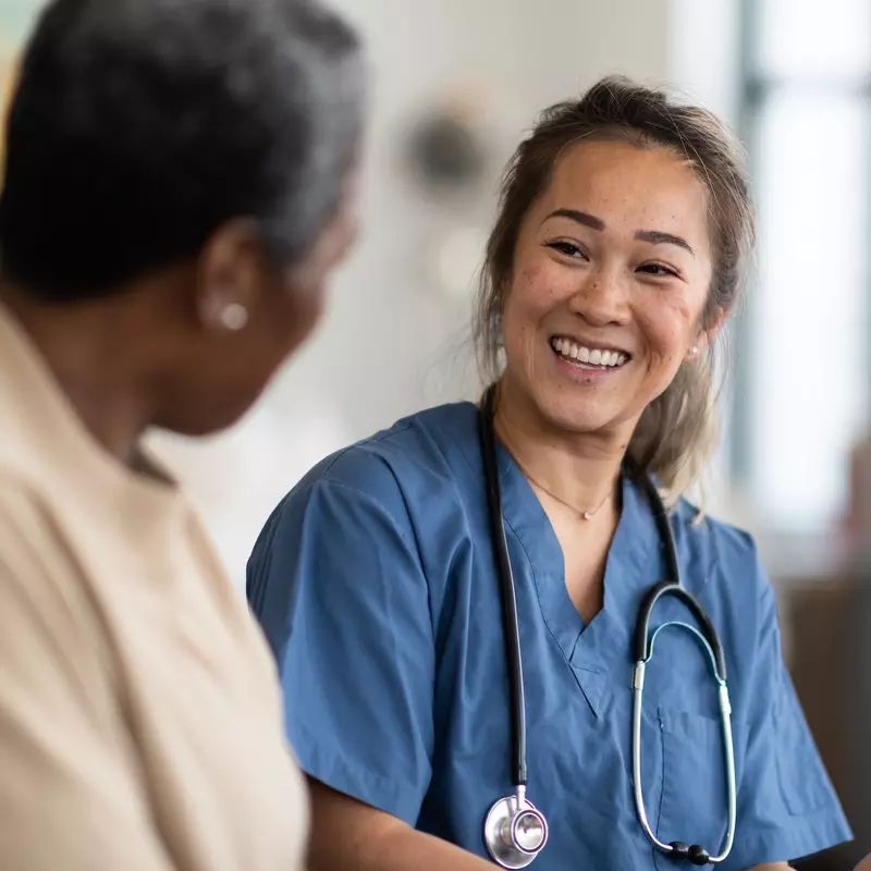 A woman talks with her doctor about her test results.