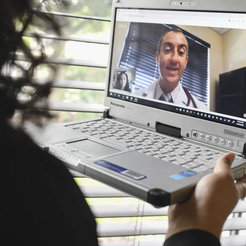 A woman has a video visit with her AdventHealth doctor. 