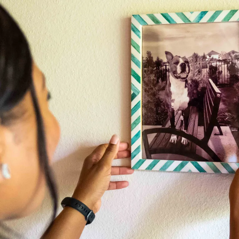 woman handing picture of dog