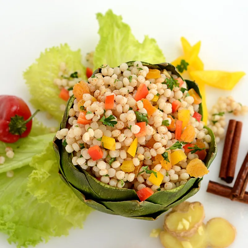 seasoned couscous pearls plated inside an artichoke