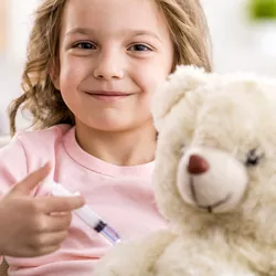 child smiling while posing for a shot