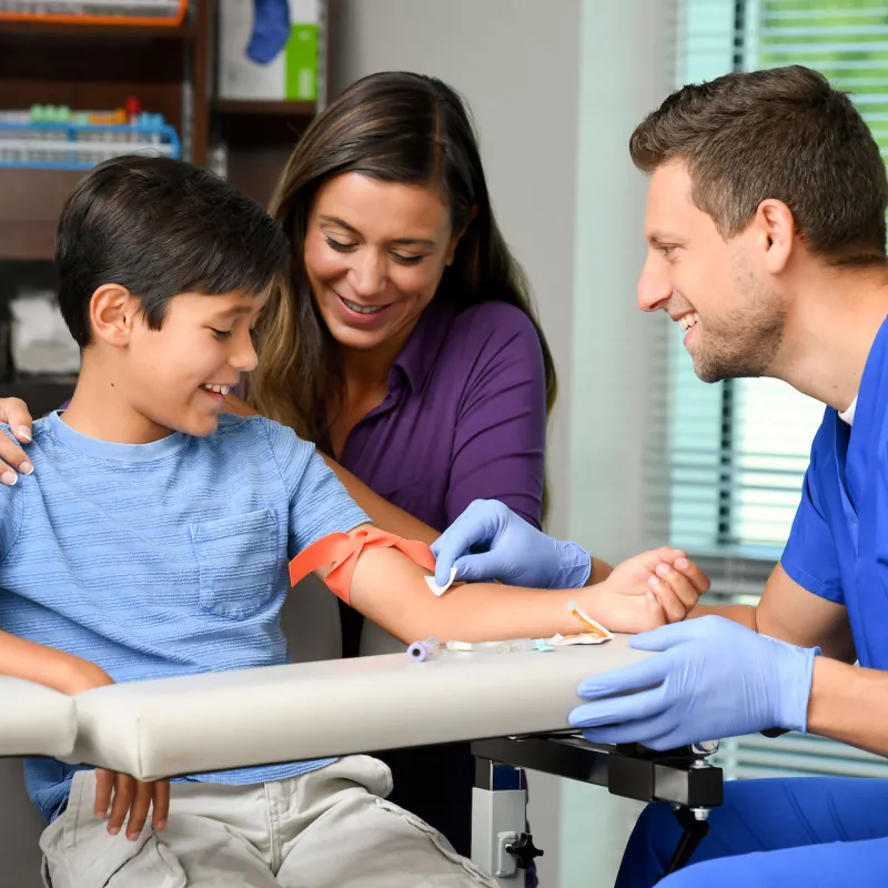 Male lab technician treating a young patient