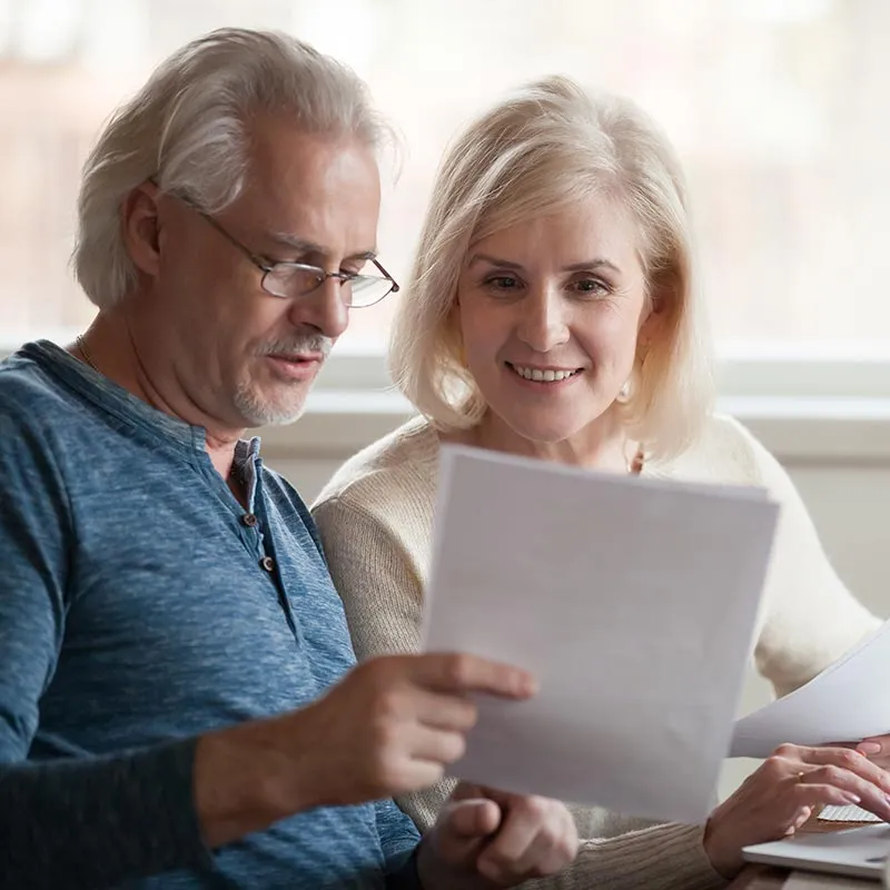 Man and woman reading a document together