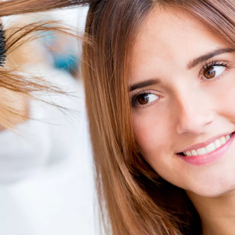 A white young woman getting her hair done