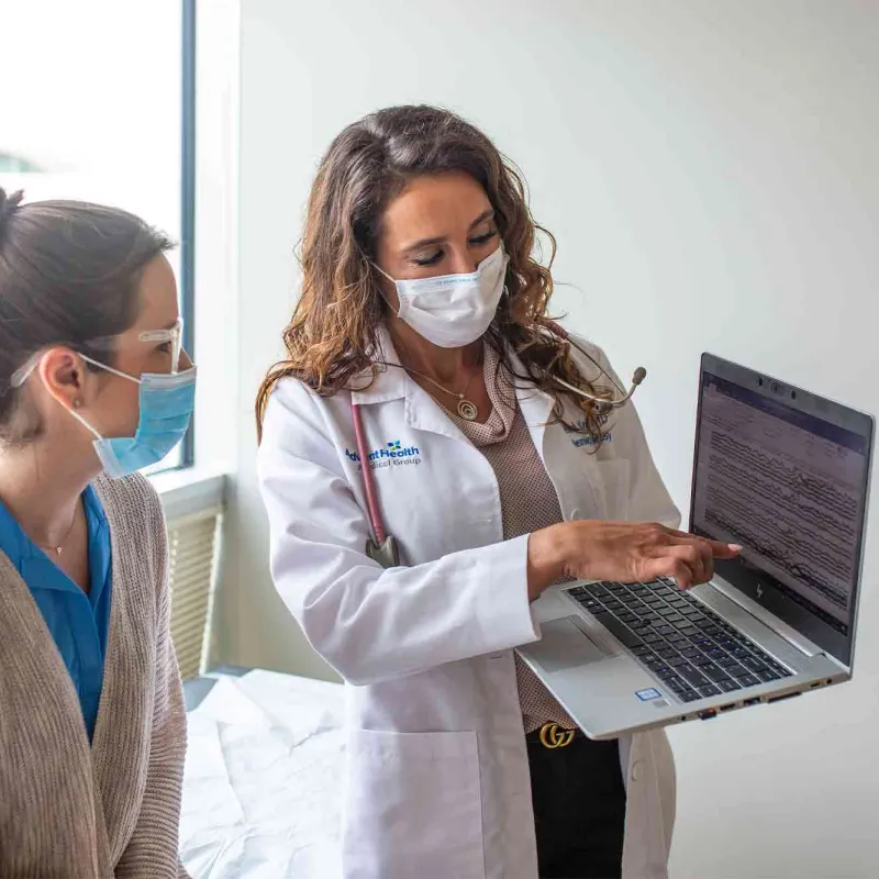 Physician showing a patient something on a laptop