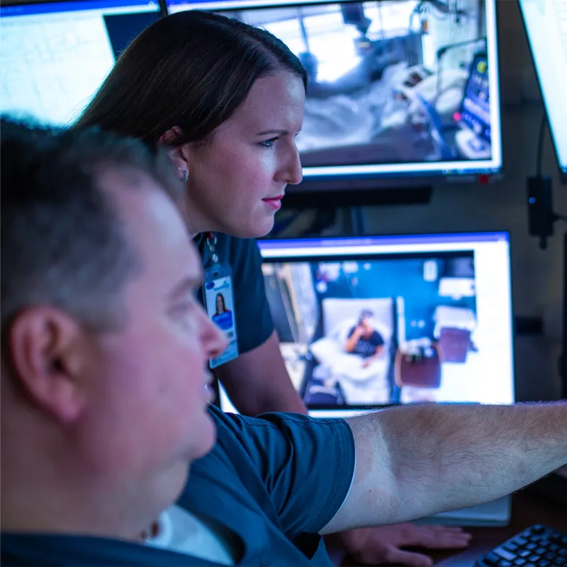 Technicians looking at rain scans.