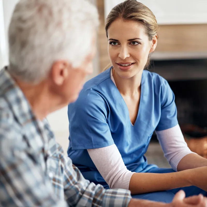 Nurse speaking with an elderly patient