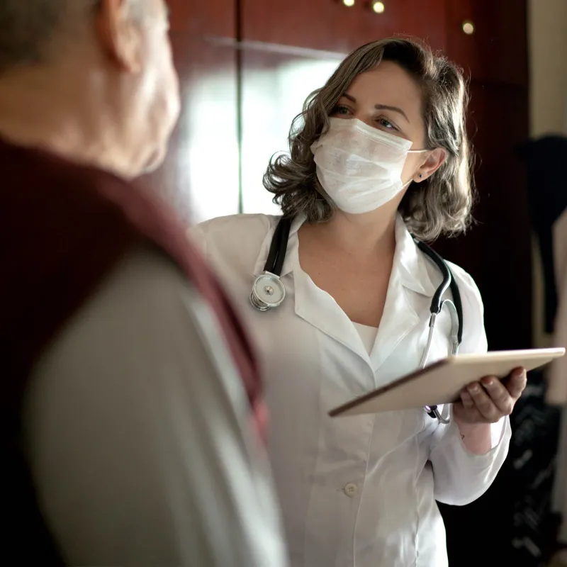 An older man talking to his doctor. 