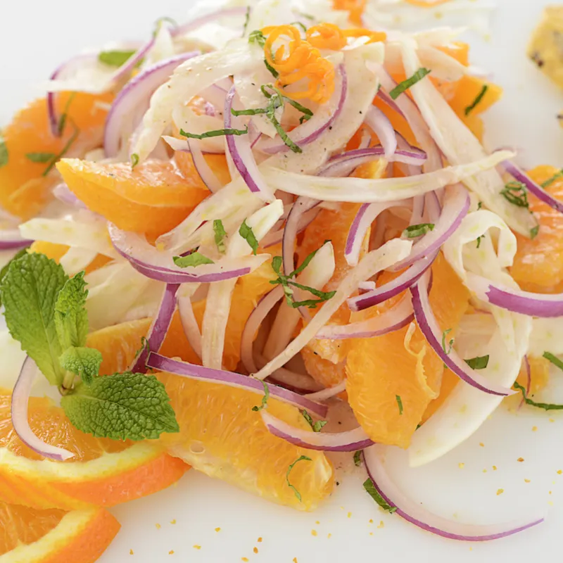 Mound of orange fennel salad with orange garnishes