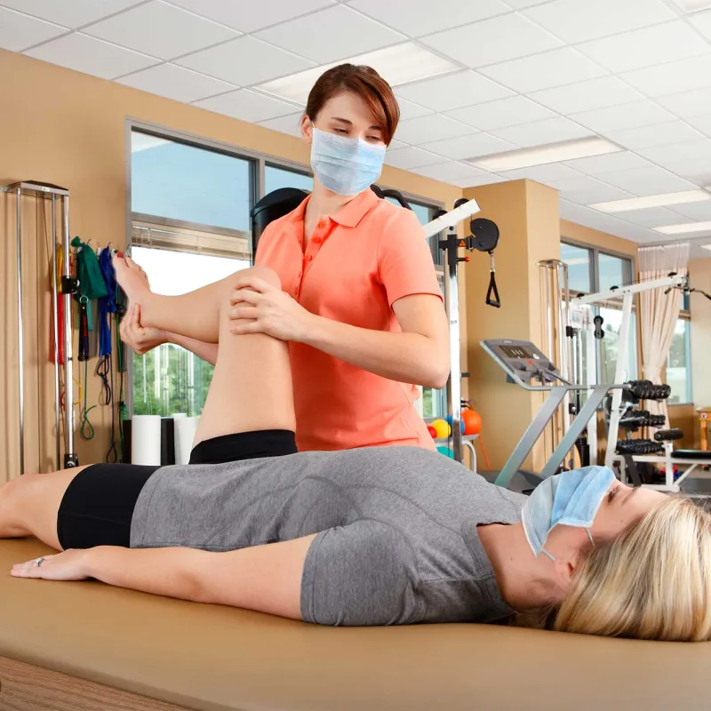 A woman getting physical therapy done by a female specialist