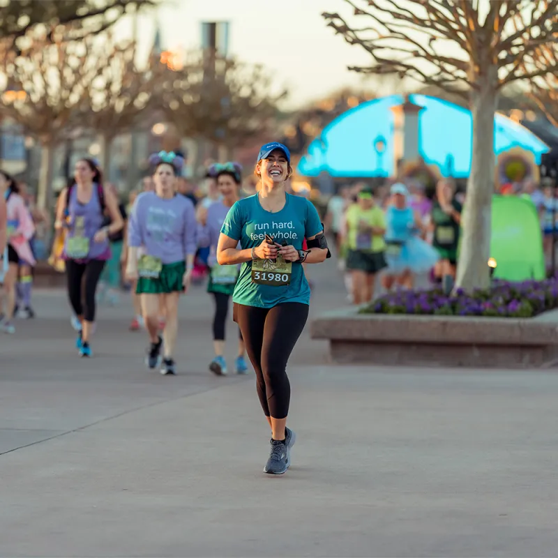 Woman running runDisney Princess 10k runner at Epcot.